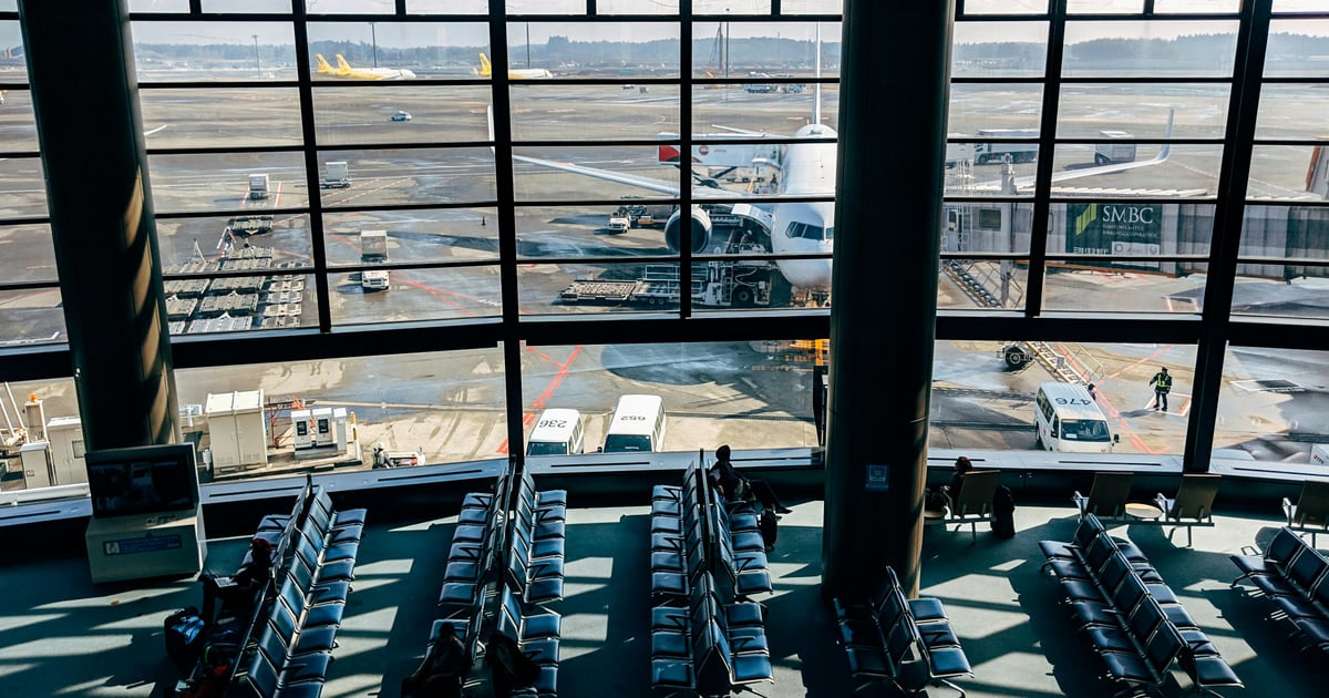 Spacious airport terminal with airplane and tarmac view in Tokyo, Japan.