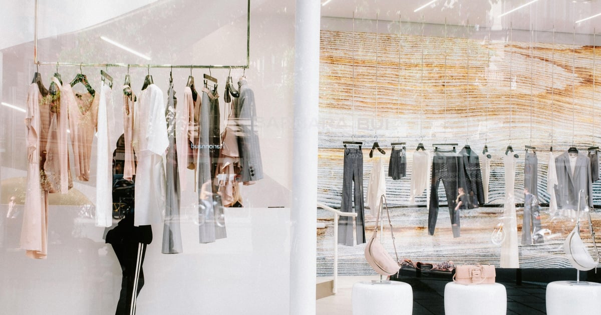 Chic fashion display at a clothing store with stylish reflections.
